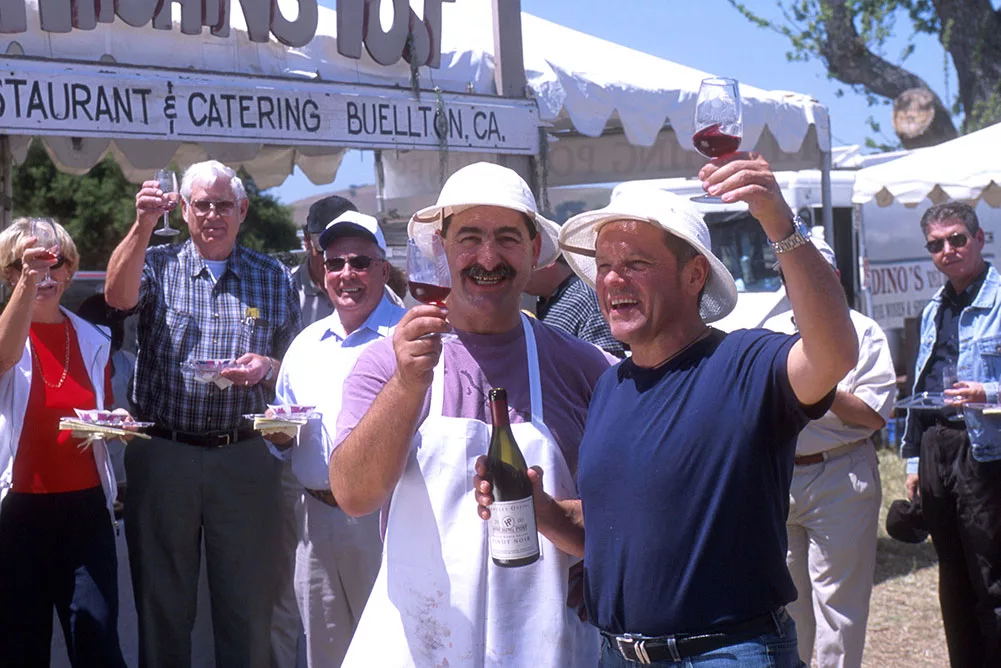 Group celebrating outdoors with wine