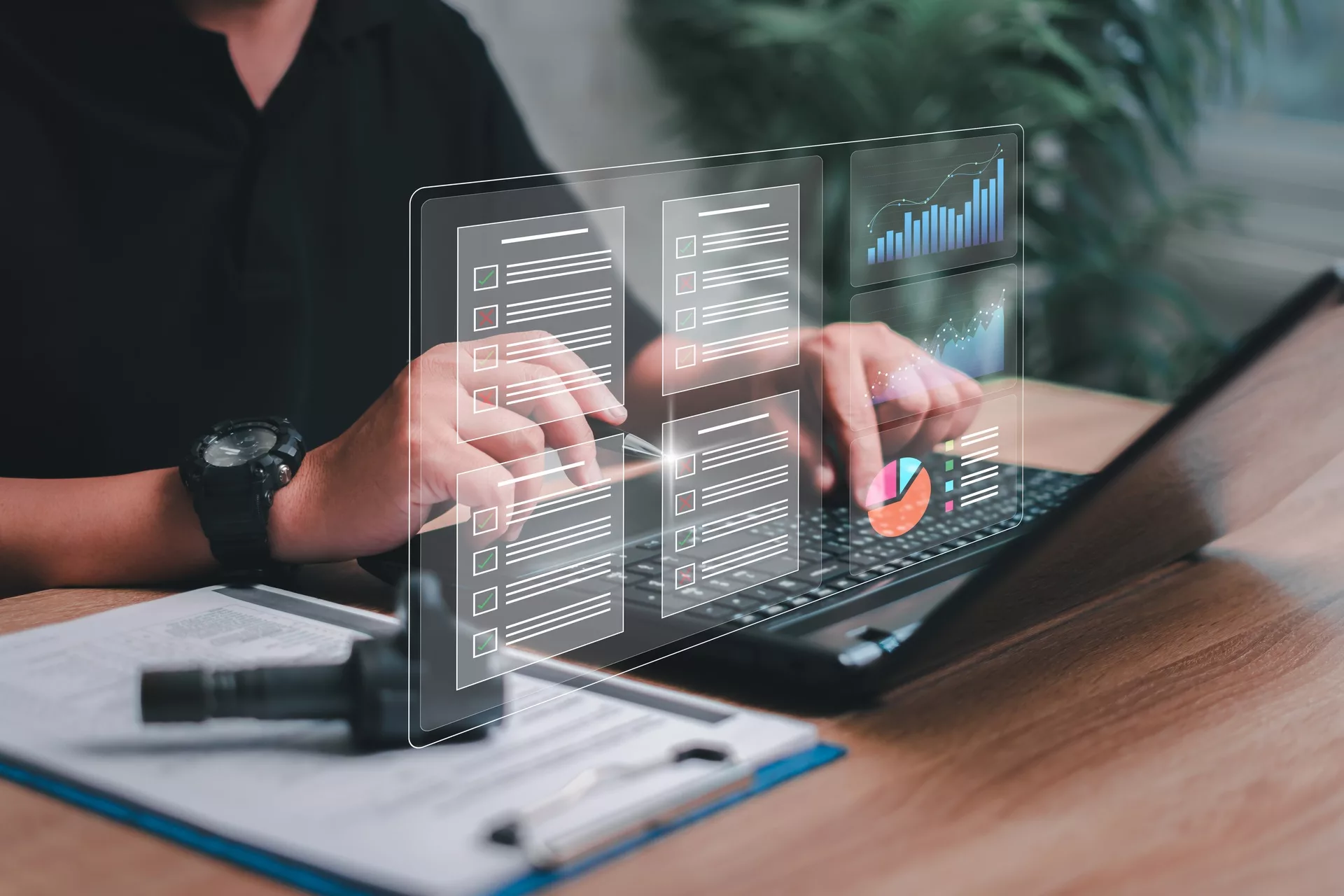 Person using laptop with digital graphs and analytics