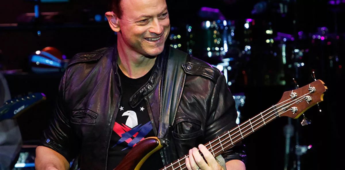 Musician playing a bass guitar on stage