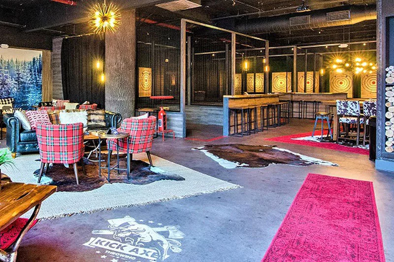 Cozy axe-throwing lounge with plaid chairs