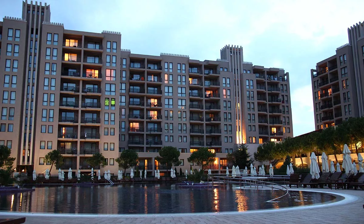 Modern apartment complex illuminated at dusk