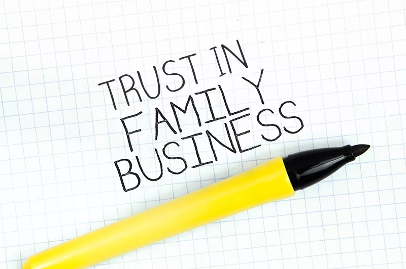 Yellow highlighter on graph paper with "Trust in Family Business" written in bold black letters.