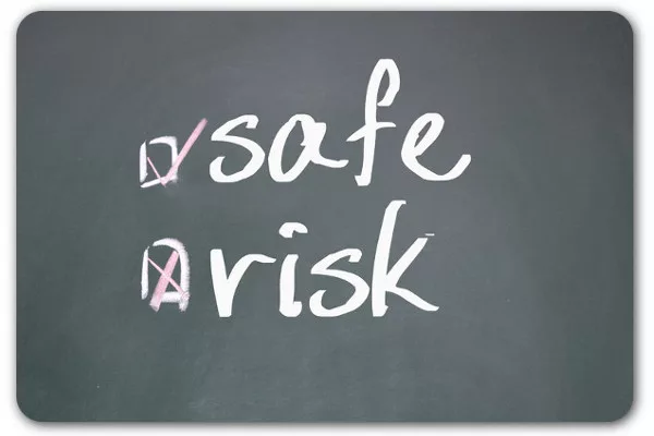 Chalkboard shows "safe" checked and "risk" crossed out