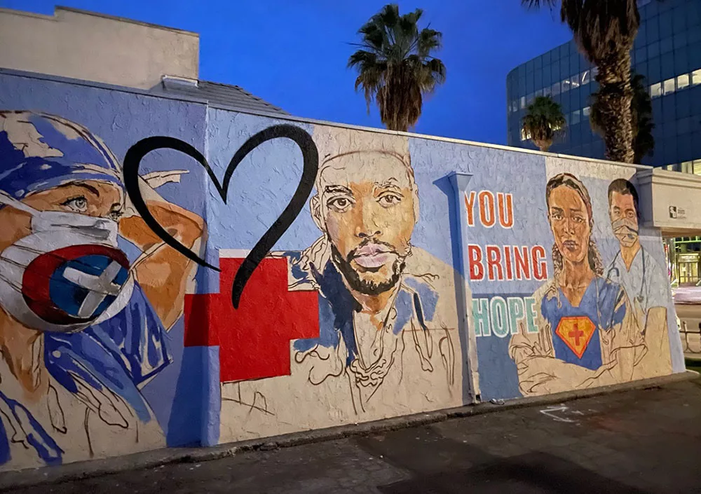 Mural of healthcare workers with heart and "You Bring Hope" text