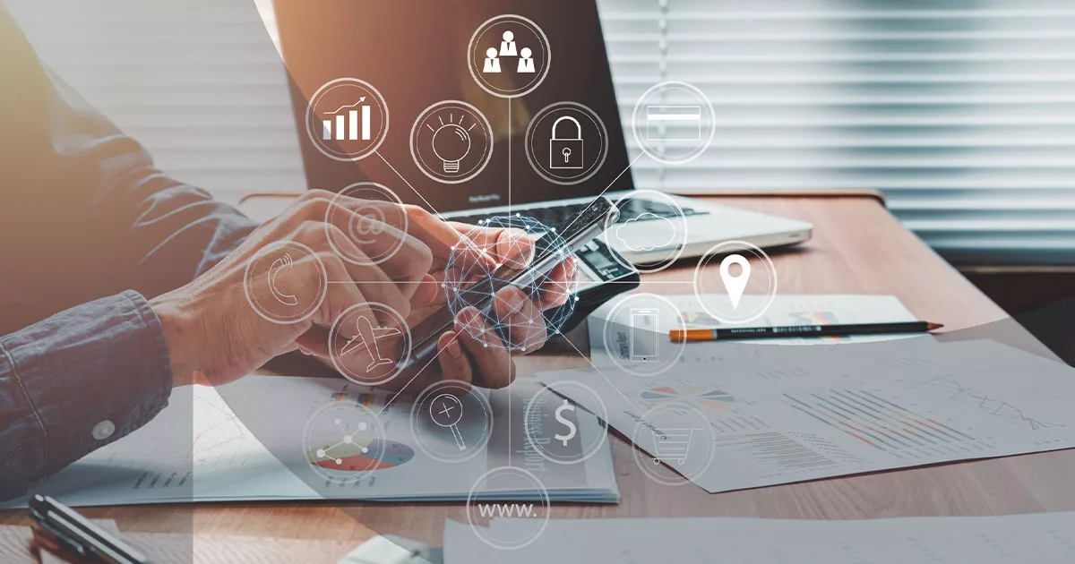 Businessman using smartphone with digital marketing icons overlay