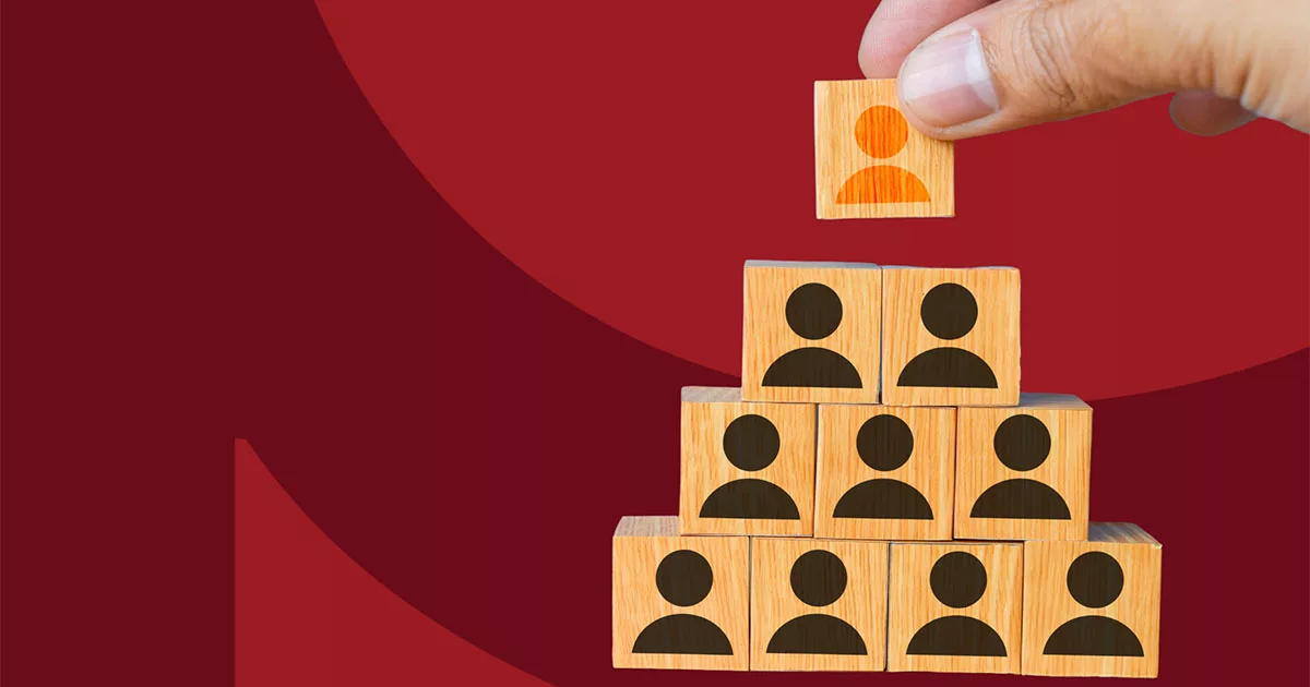 Wooden blocks with person icons form a pyramid