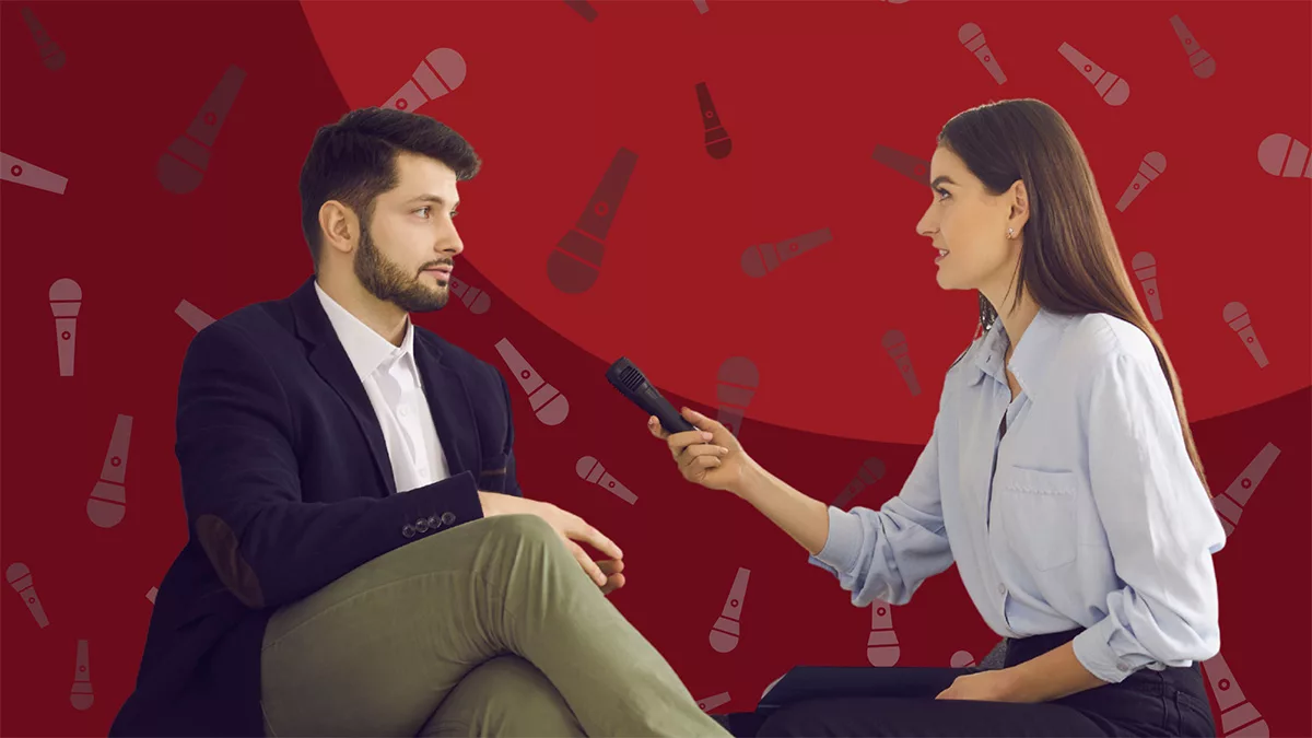 Woman interviewing a man on a red background with microphone icons. He wears a blazer and she holds a microphone.