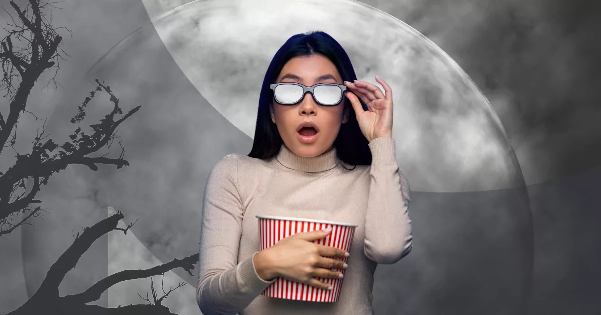 Woman with 3D glasses holding popcorn
