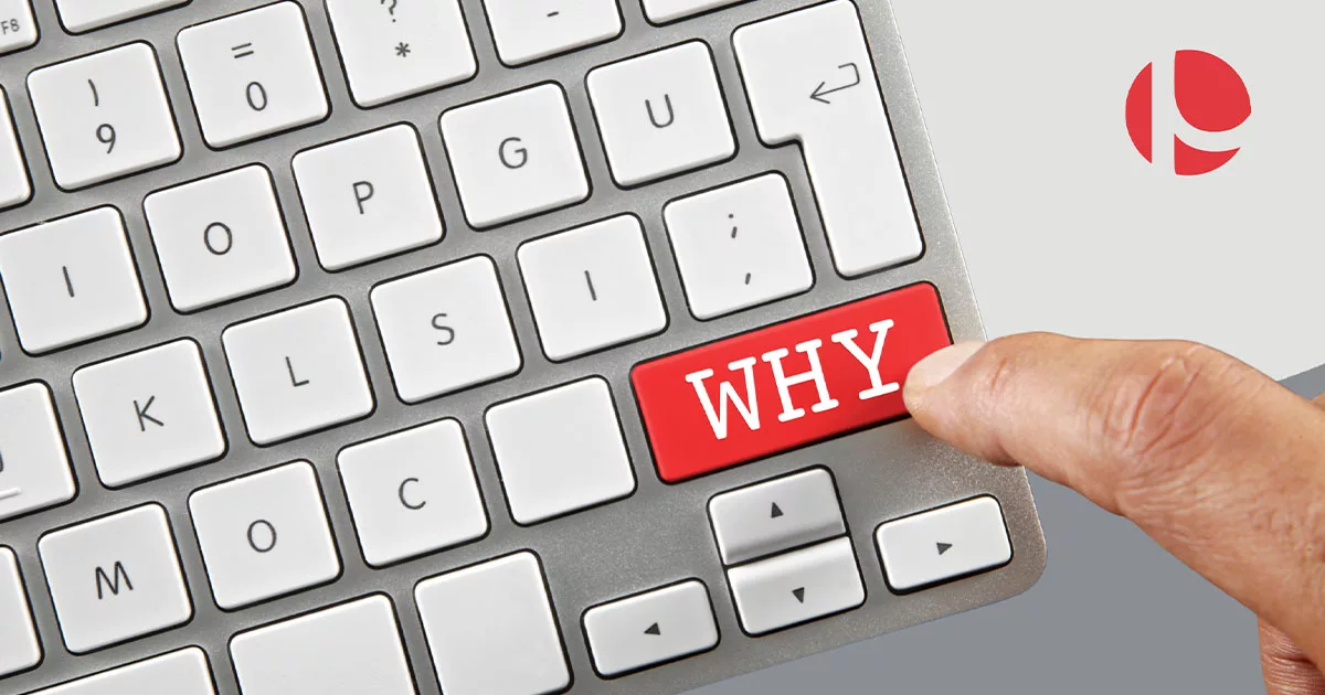 Finger pressing a red "WHY" key on a silver keyboard