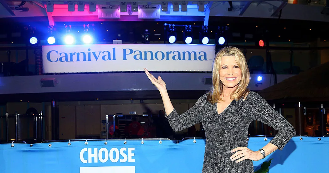 Smiling woman presenting Carnival Panorama ship sign