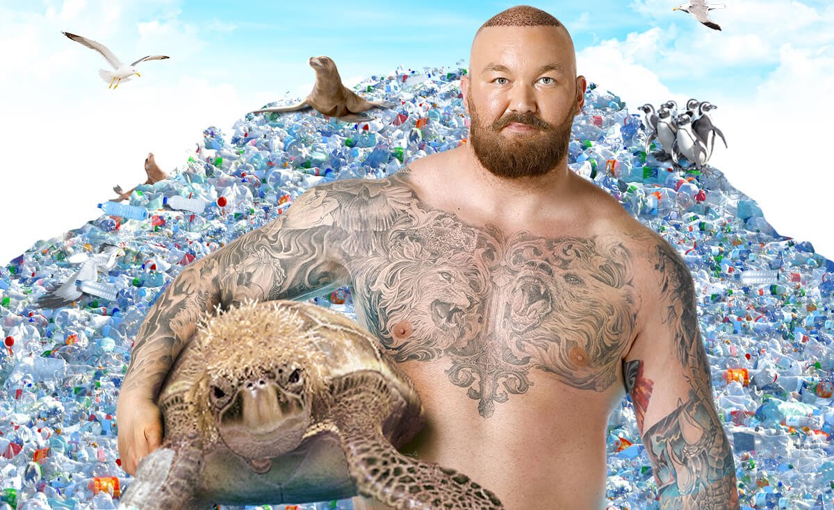 Man with tattoos holding a sea turtle