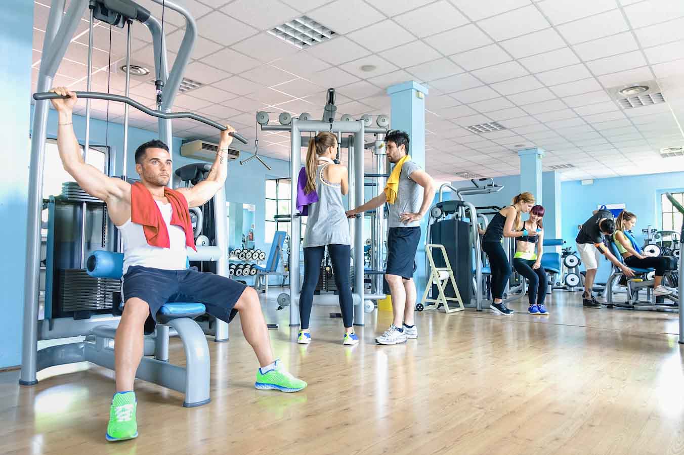 People working out in a gym with exercise machines