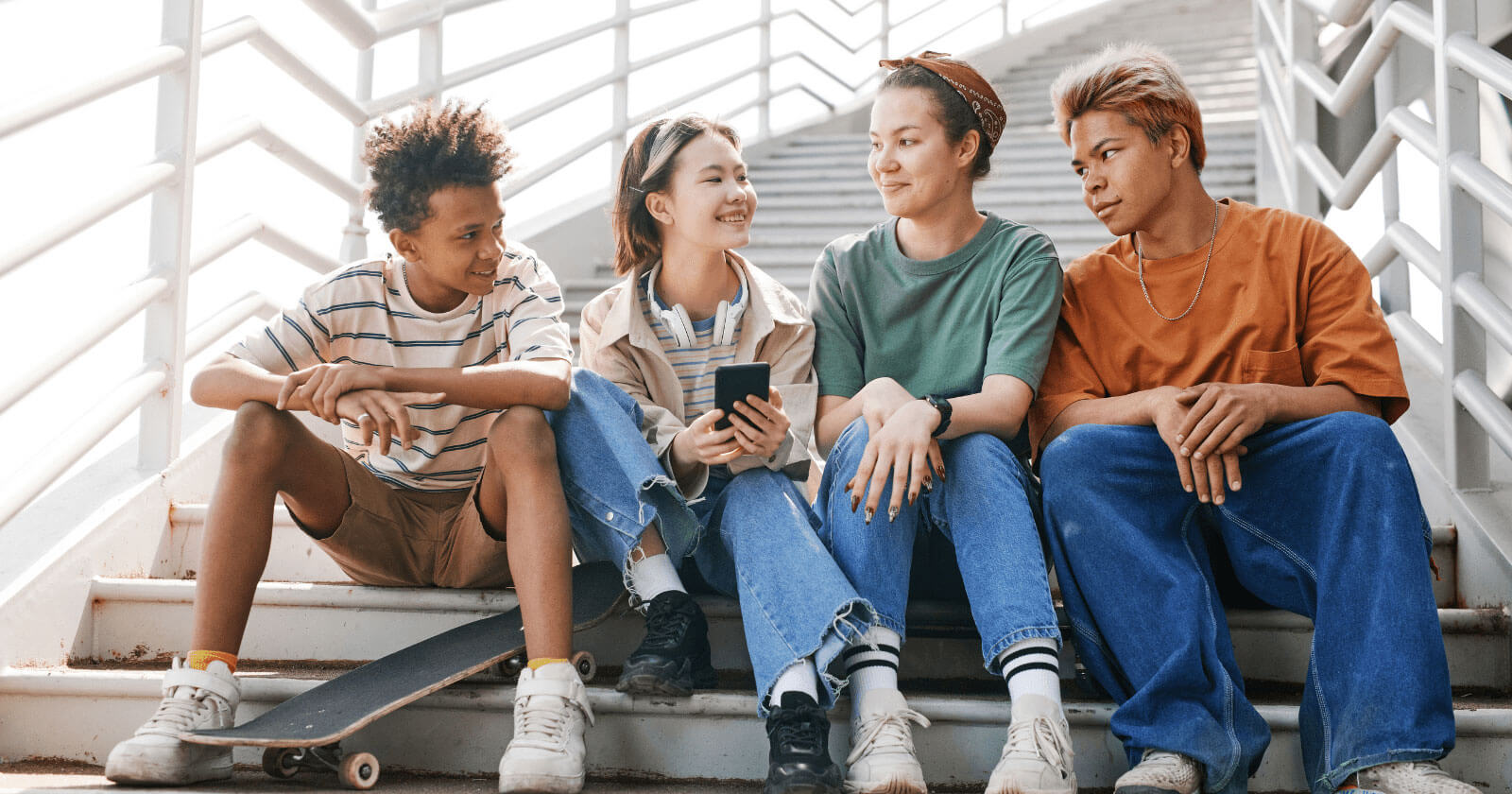 Group of diverse teens sitting on stairs