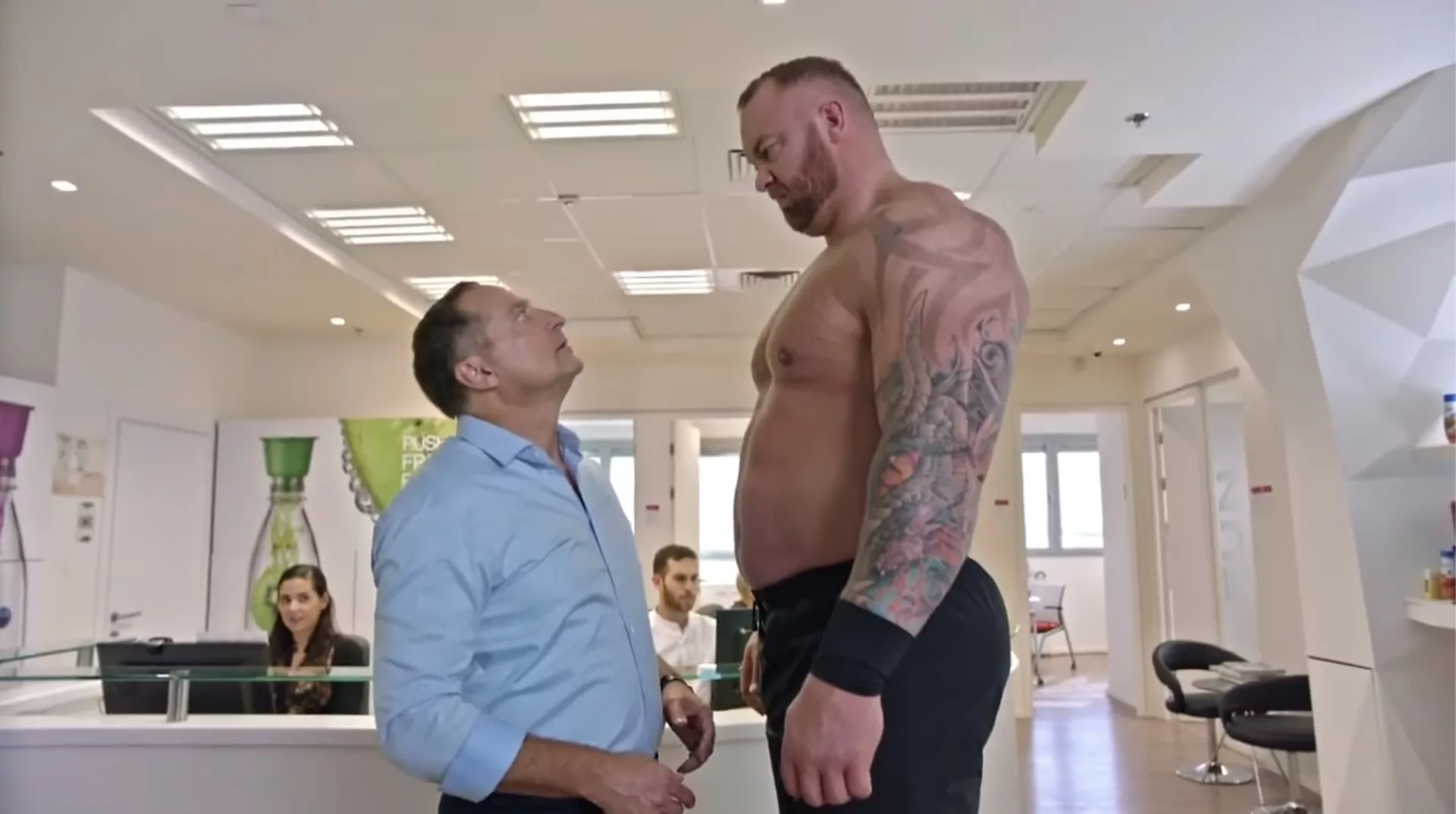 Two men facing each other in an office
