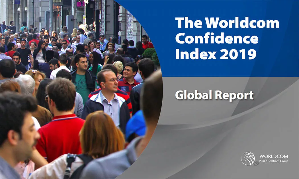 Crowded urban street scene next to Worldcom Confidence Index 2019 Global Report cover text.