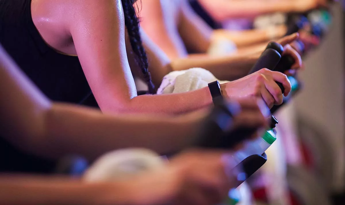People exercising on stationary bikes indoors