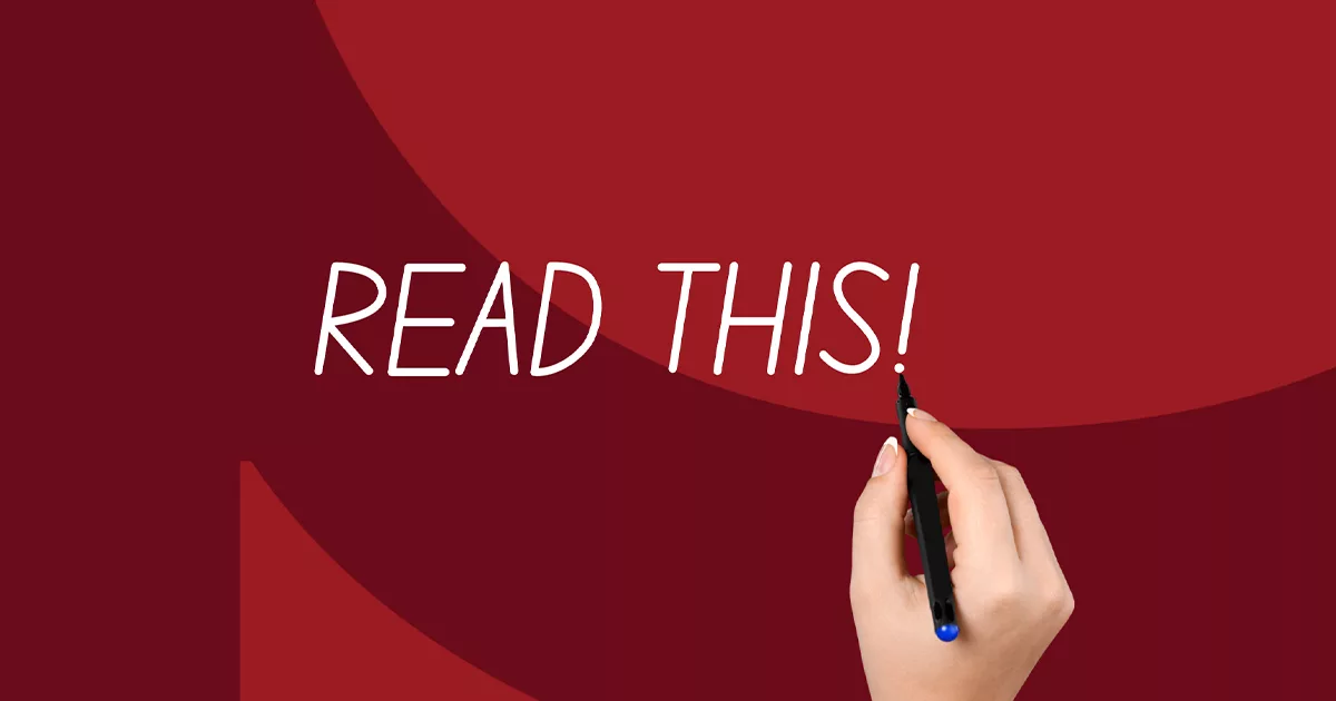 Hand writing "Read This!" with black pen on red background.