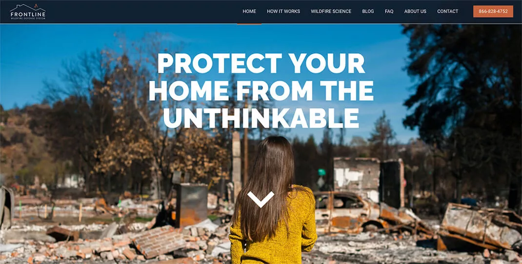 Woman in yellow jacket stands before wildfire ruins