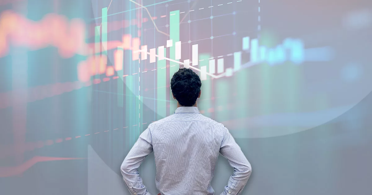 Man analyzing colorful stock market graph on a large screen.