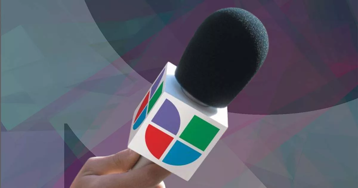 Hand holding a microphone with geometric logo on a colorful abstract background.