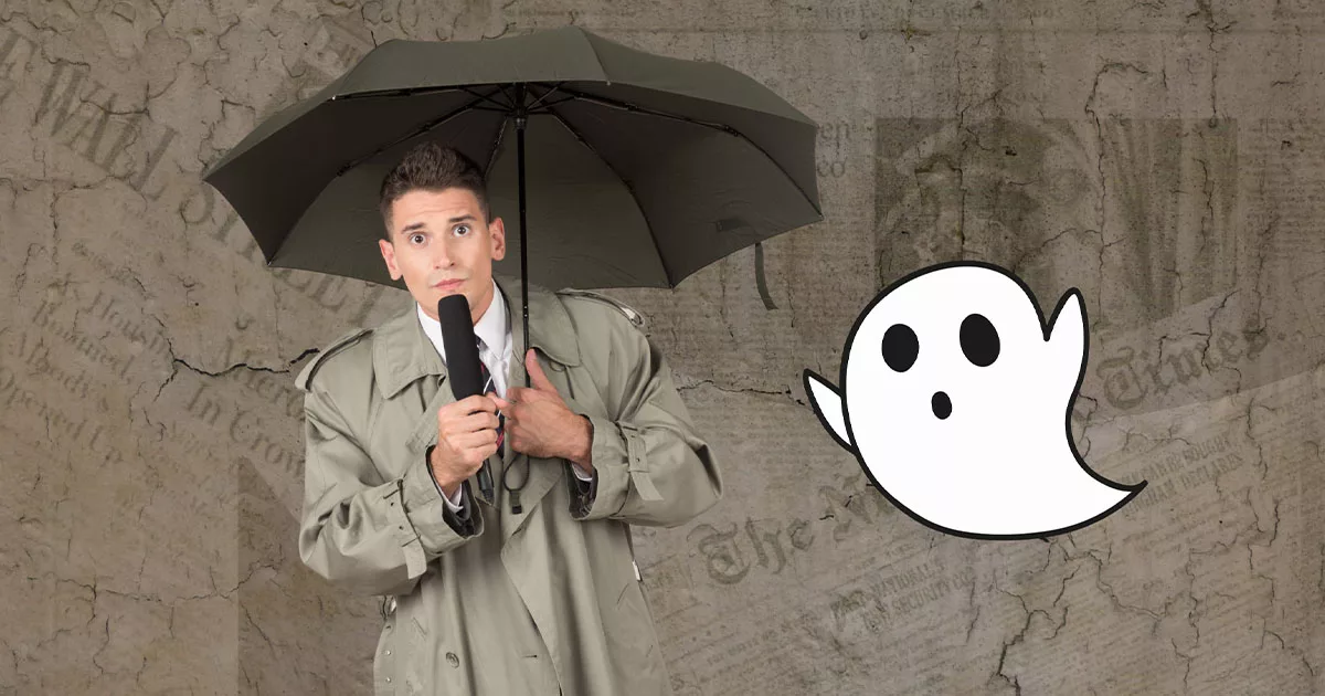 Man in trench coat holds umbrella and microphone