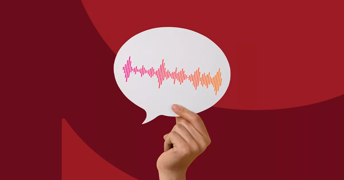 Hand holds speech bubble with colorful soundwave on a red background.