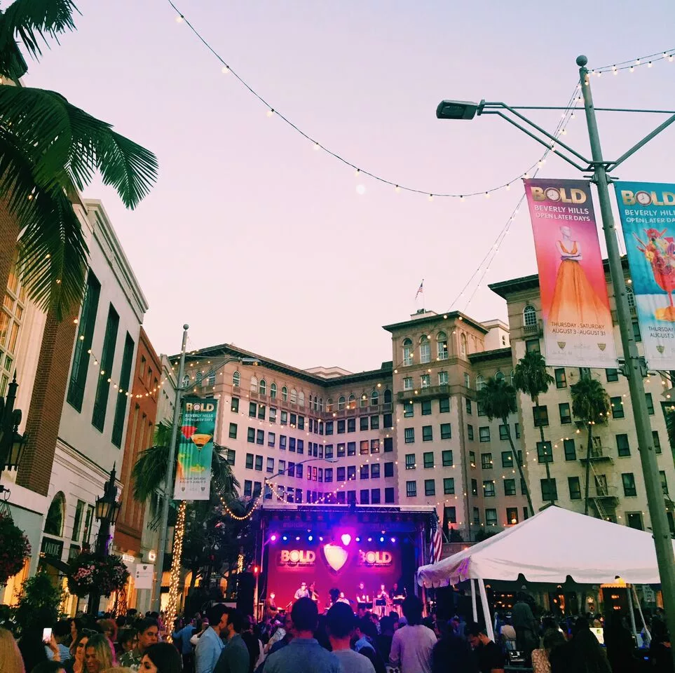 Outdoor concert at sunset in Beverly Hills with a lively crowd