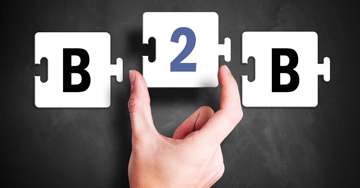 Hand placing puzzle piece with '2' between 'B' pieces on chalkboard background