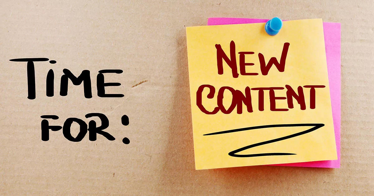 Sticky note with "New Content" on corkboard