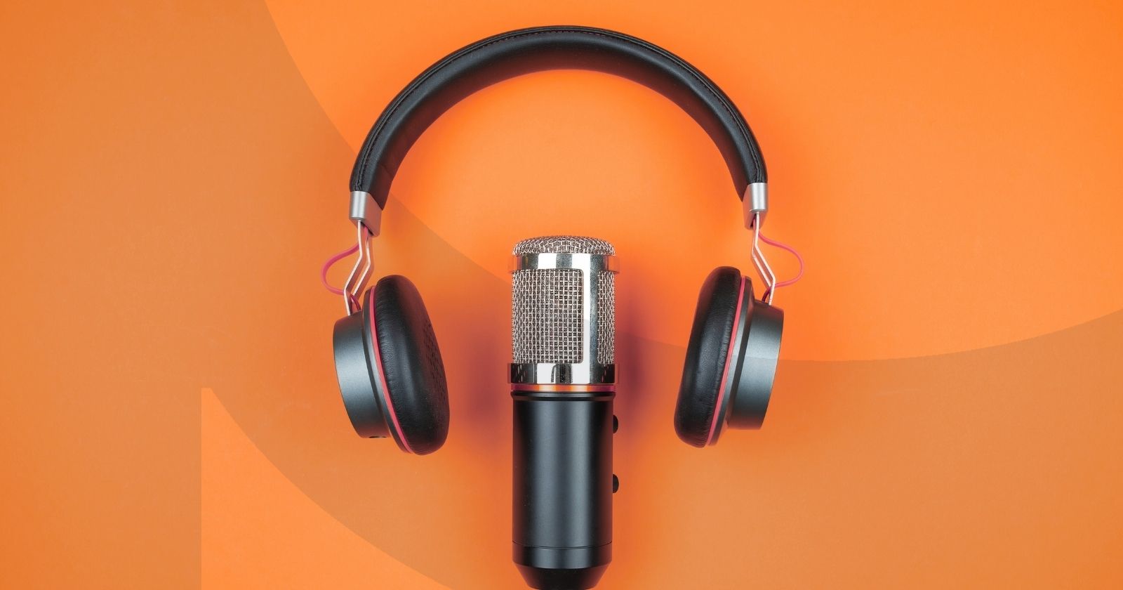 Microphone and headset laying down on an orange background