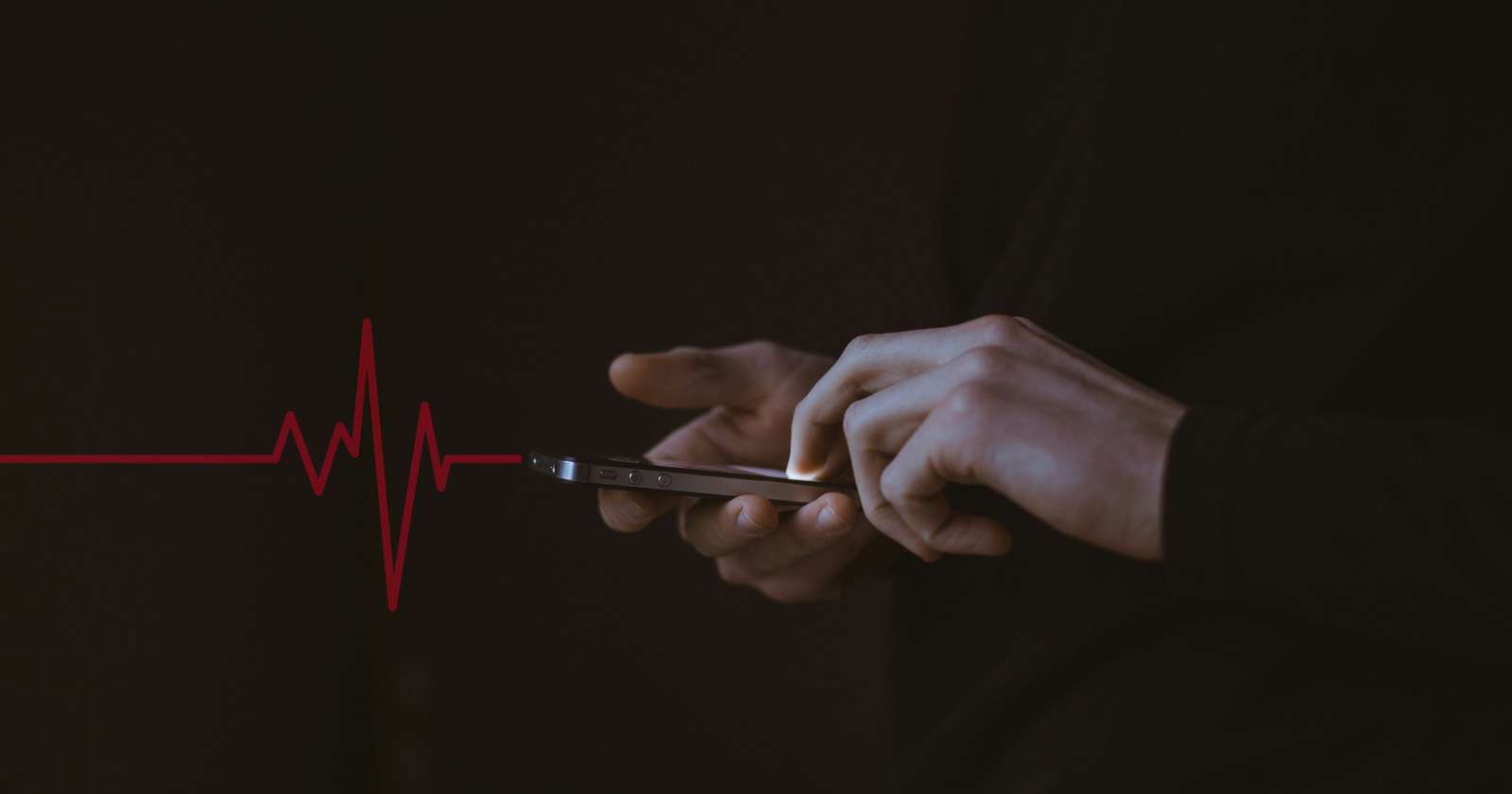 Hands using smartphone with heartbeat line overlay