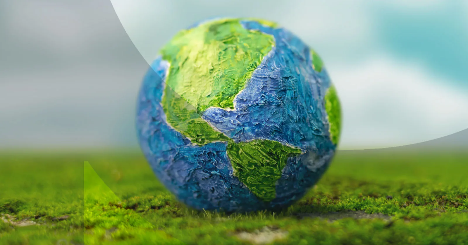 Clay Earth model on fresh green grass