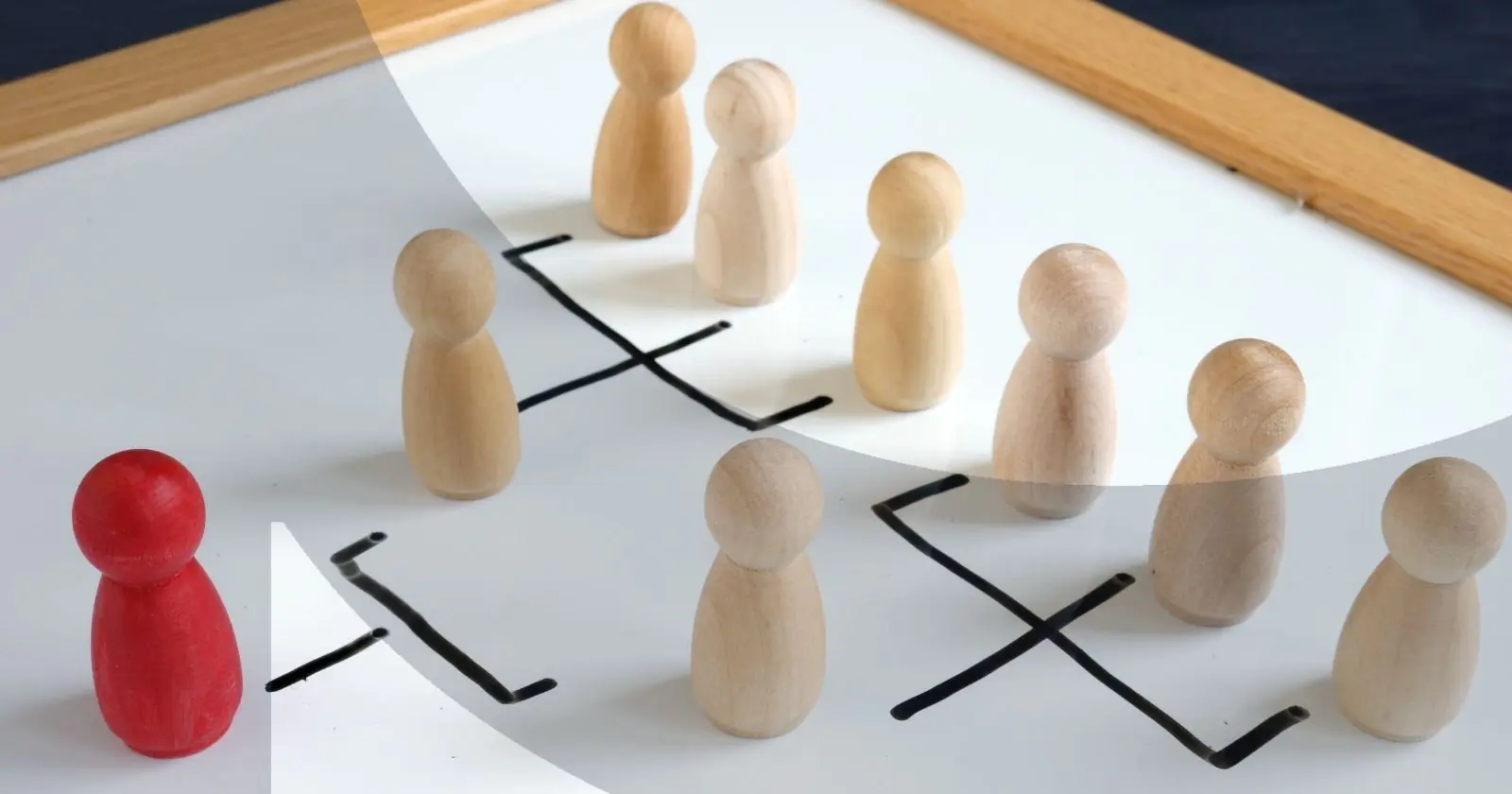 Red pawn facing wooden pawns on a whiteboard hierarchy chart.