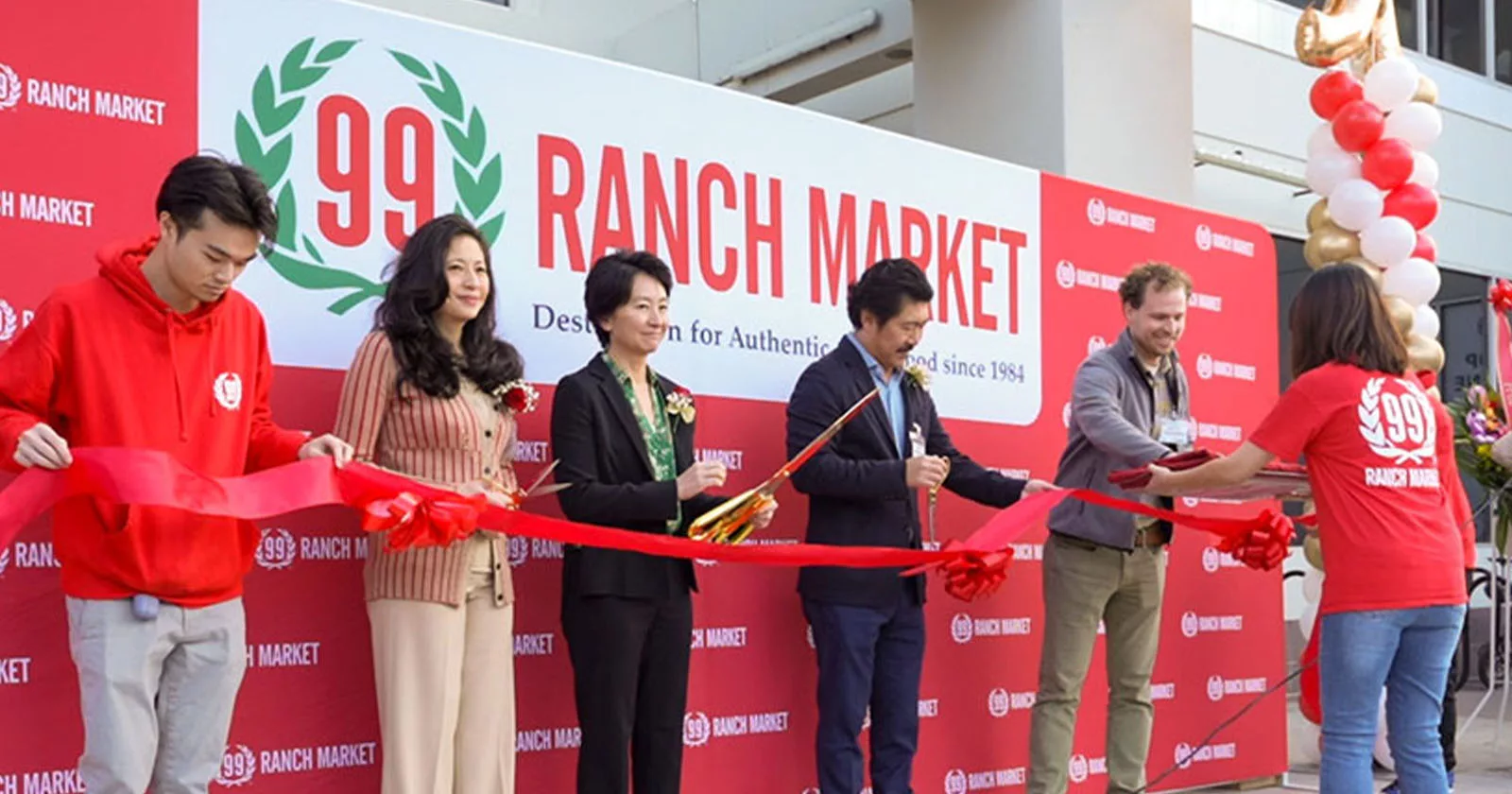 Group cutting red ribbon at 99 Ranch Market opening ceremony