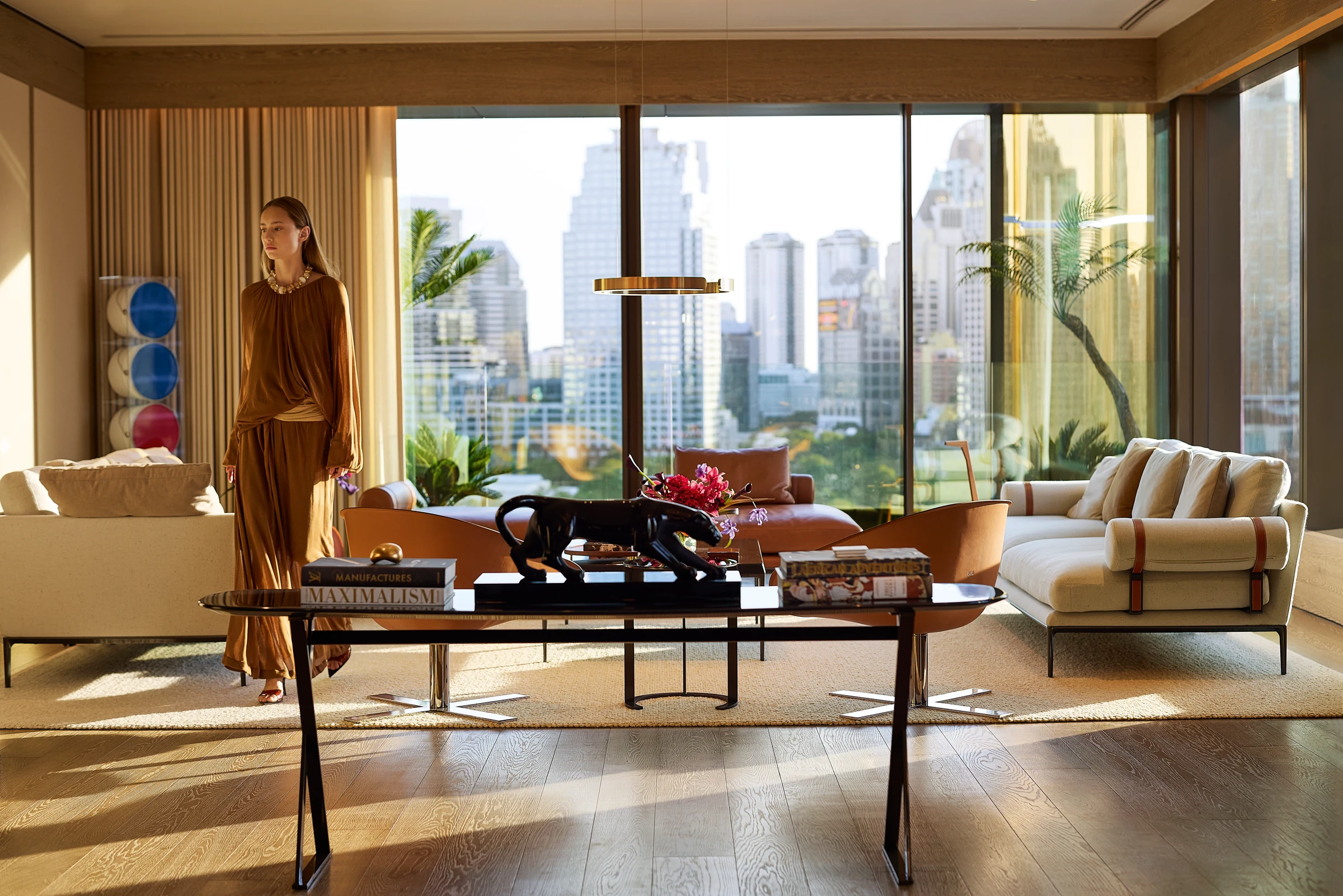 A Sunset Residence living room with floor-to-ceiling windows and city views.