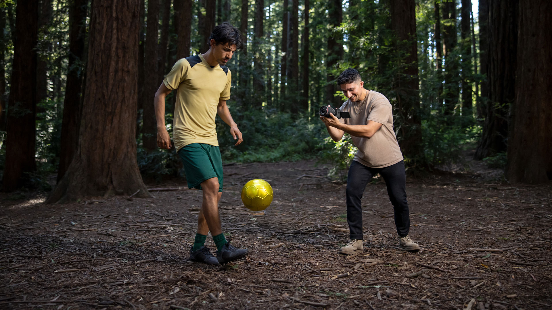 Canon USA, O2O, Stills: Evan Ruderman, shot of man filming footballer in the forest