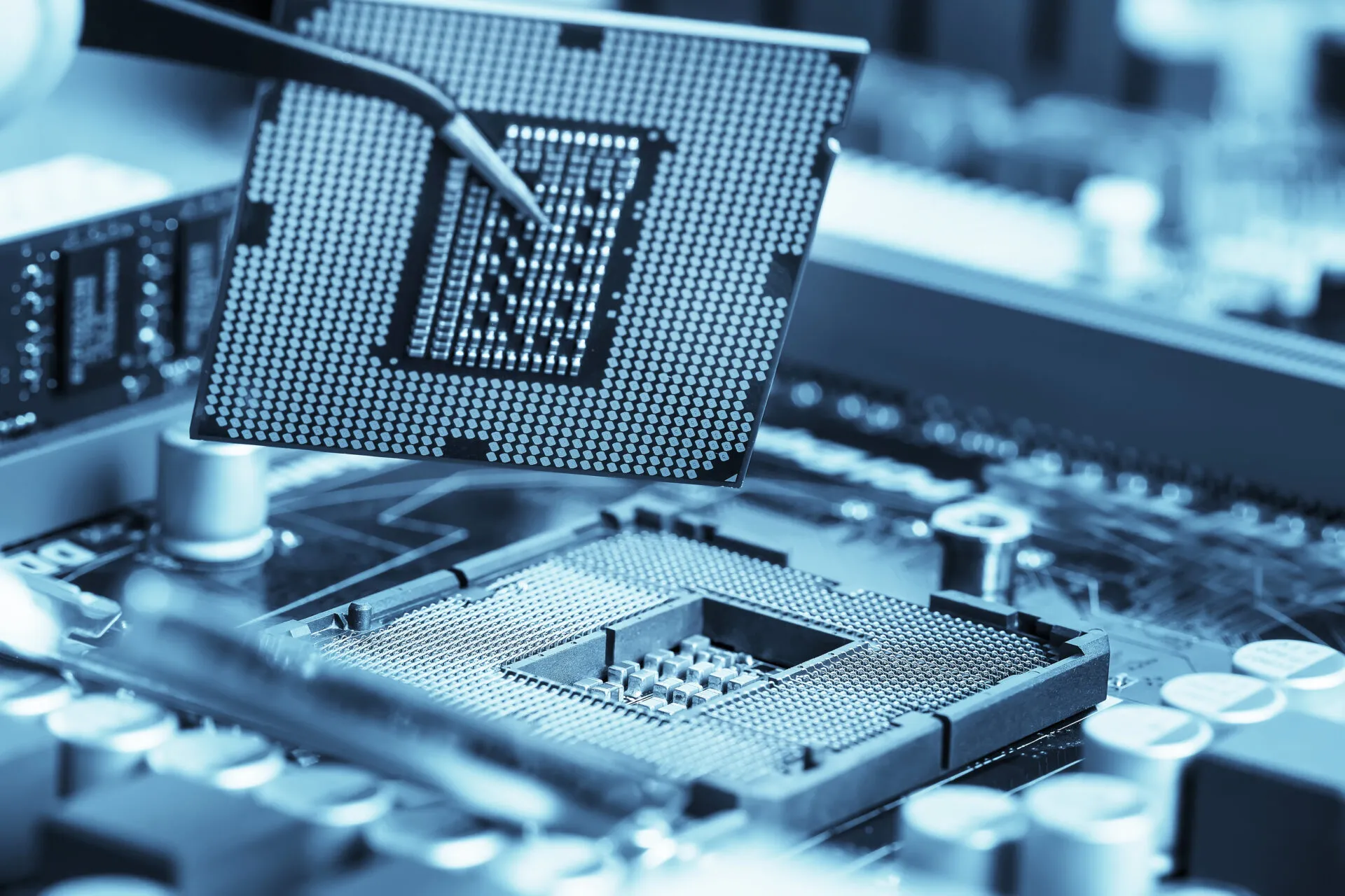 Close-up of a processor being placed onto a circuit board during precision electronic assembly