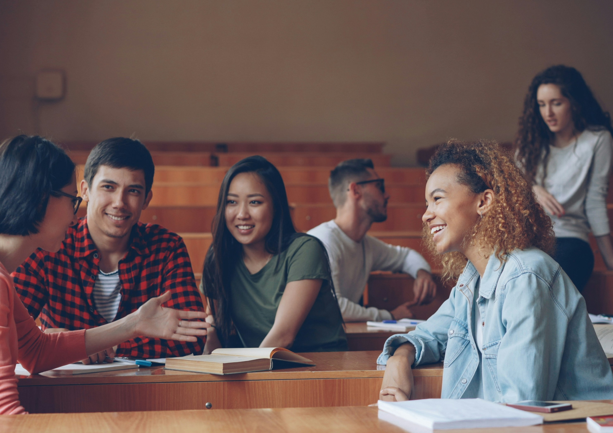 Group of students talking in lecture hall