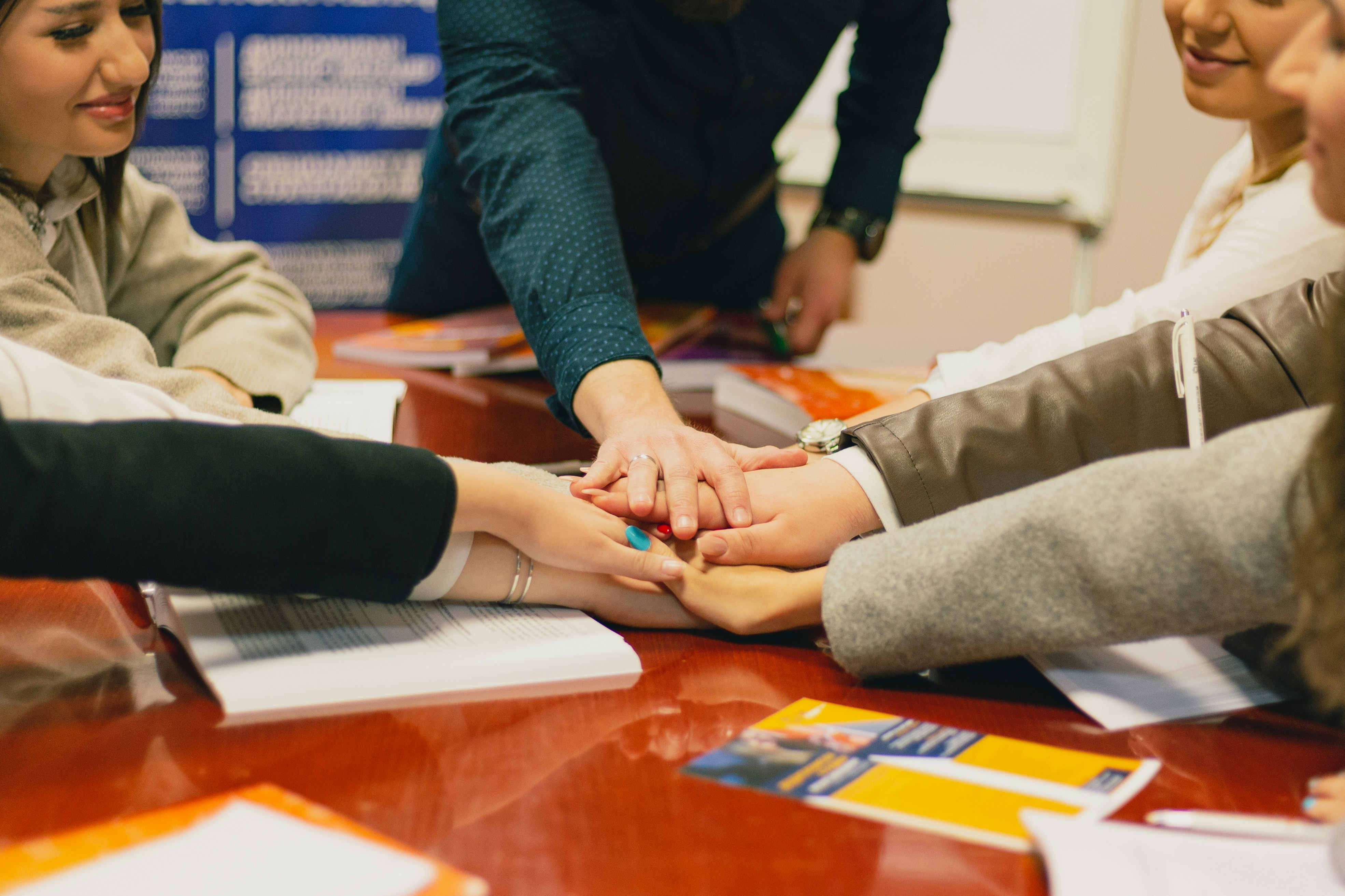 Team putting hands together to show teamwork