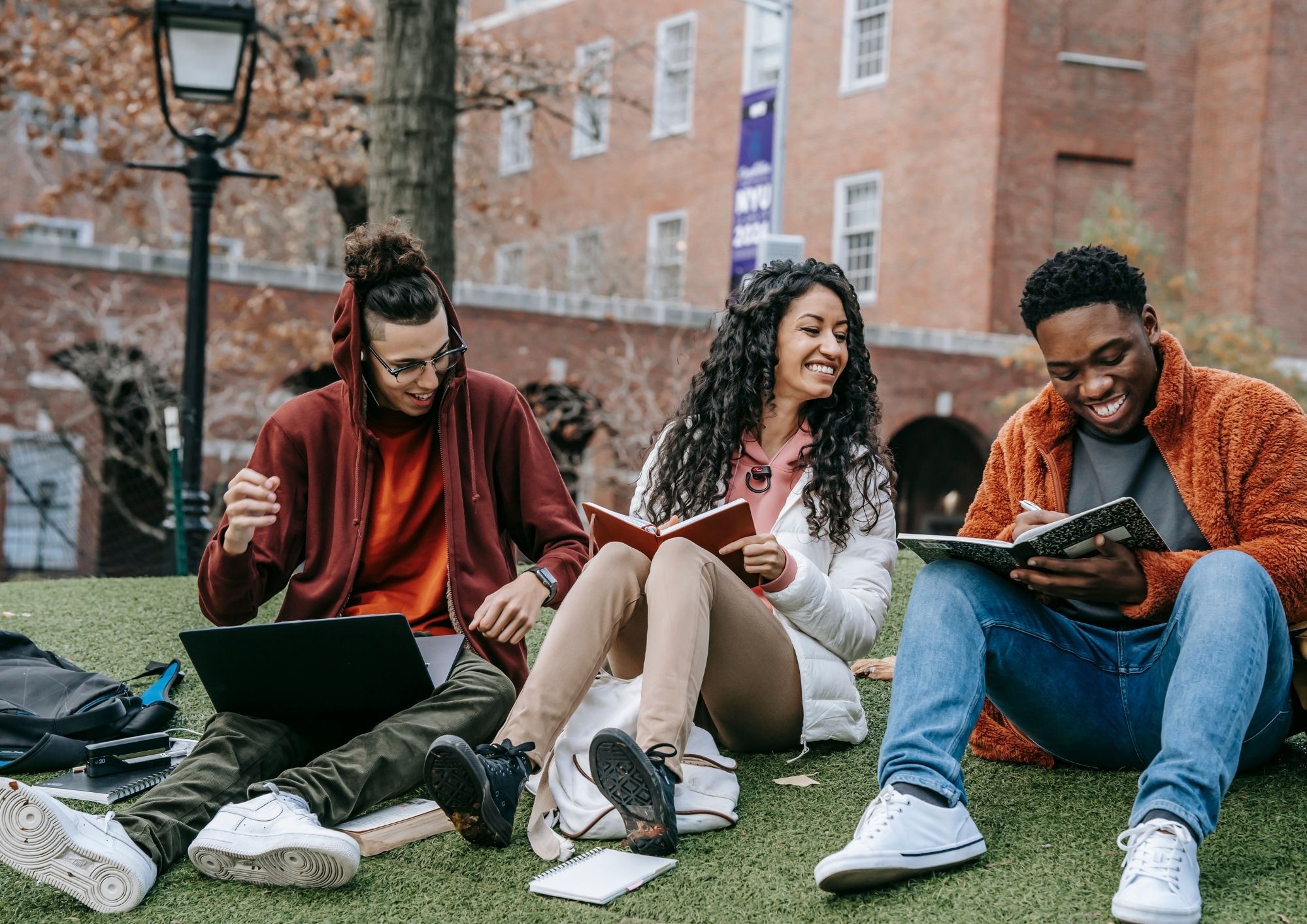 Students sitting outside on campus studying together