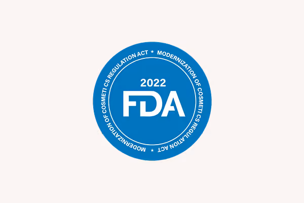 Blue circular seal with 2022 FDA in center and text about cosmetic regulation act around edge.