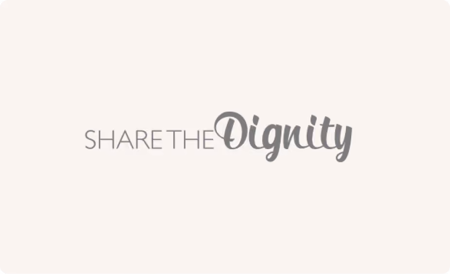 Text logo saying Share the Dignity with 'Dignity' in a cursive font.