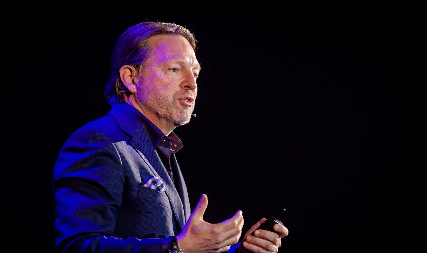 Verne Harnish speaking on stage in Europe