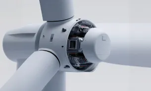 Close-up of the inner mechanical parts of a white wind turbine blade hub.