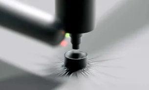 Close-up of a digital pen tip on a textured, buckle-like surface with radiating lines.