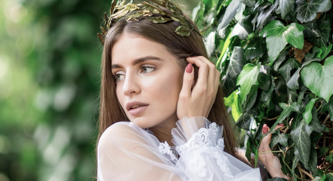 Ethereal bridal portrait featuring soft garden greenery light
