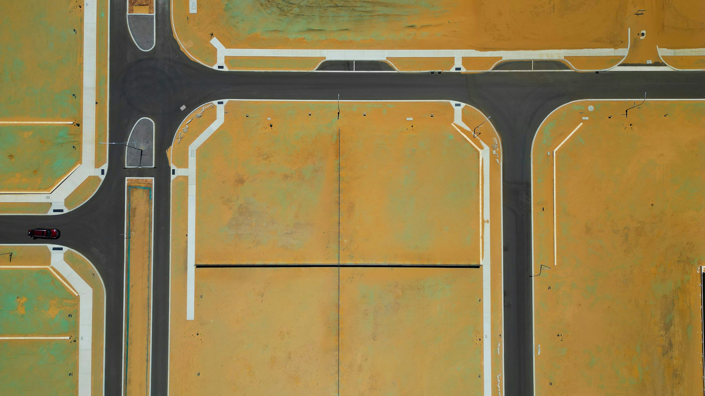 Aerial view of a new subdivision with graded lots and paved streets