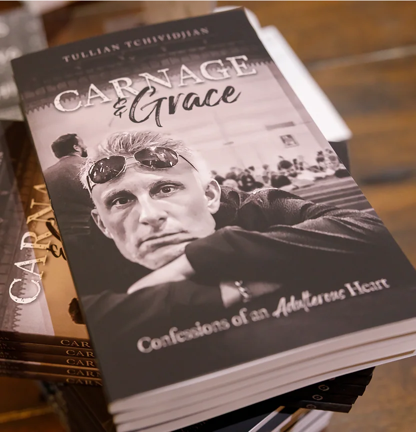 Book titled Carnage & Grace featuring a man with sunglasses on his head and subtitle Confessions of an Adulterous Heart.