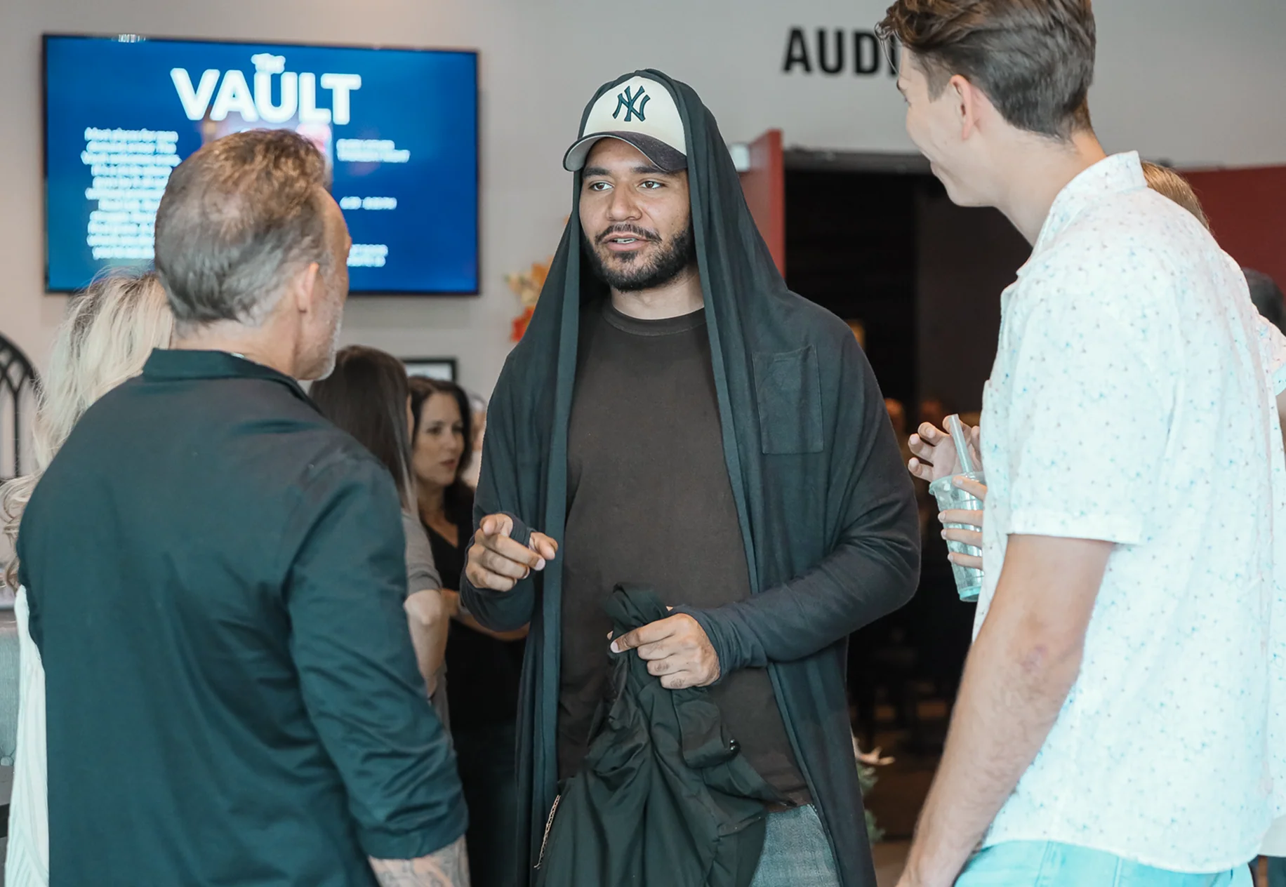 Men talking together at a church event venue.