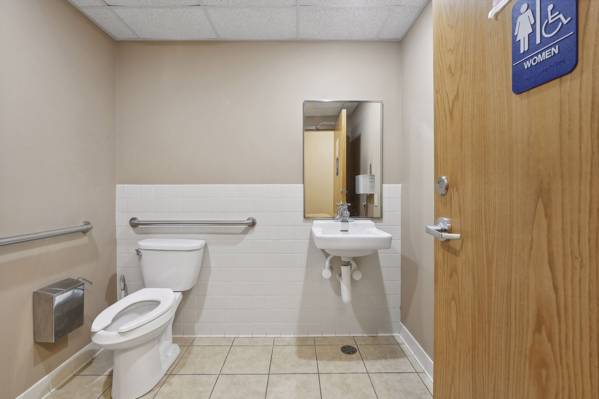 Single-occupancy accessible restroom with grab bars